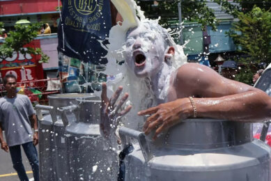 Farmers from Boyolali in Central Java brought their fresh milk to the city centre and protested by ‘bathing’ in the milk. Photo: Arief Budiman, Radar Solo